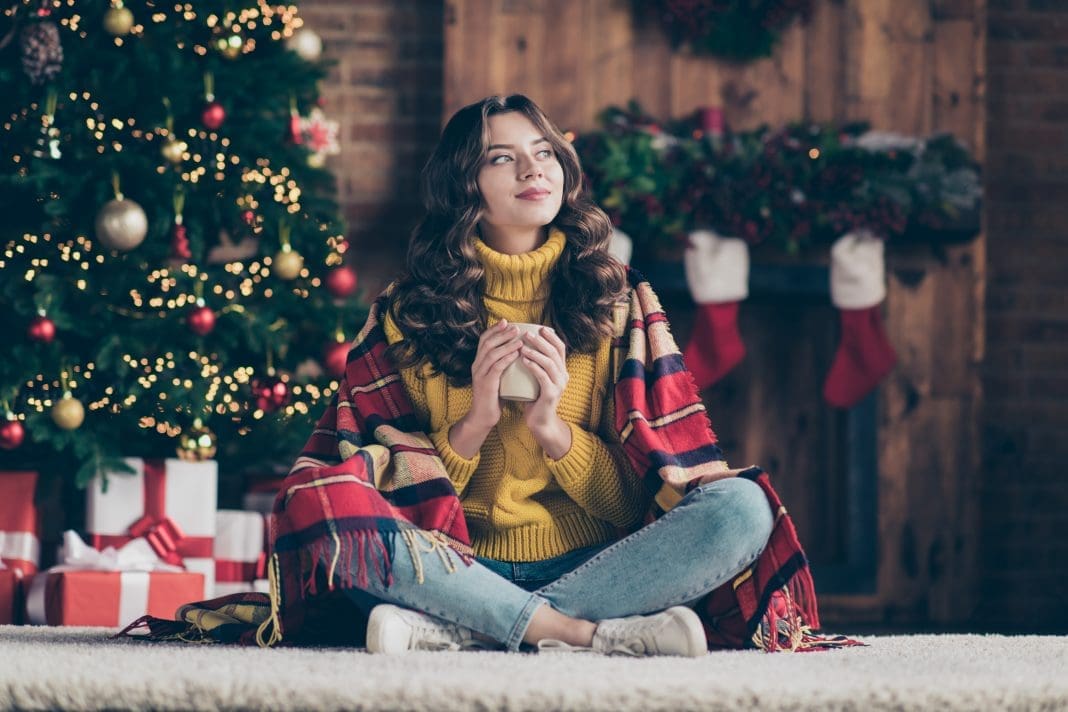 Full length body size photo of charming cute pretty girl wearing jeans denim yellow pullover with brunette hair sitting on floor staring away holding mug justämning